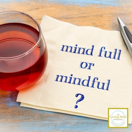 glass of red wine with a note written "mind full or mindful"